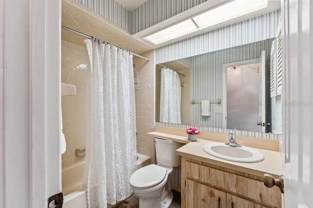 full bathroom with vanity, toilet, and shower / bath combo with shower curtain