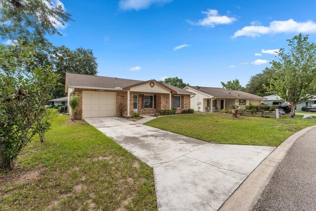 single story home with a front yard and a garage