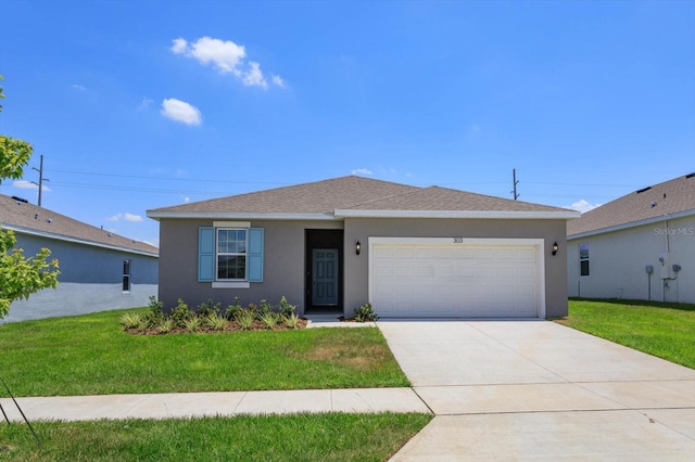 view of front of house with a front yard and a garage