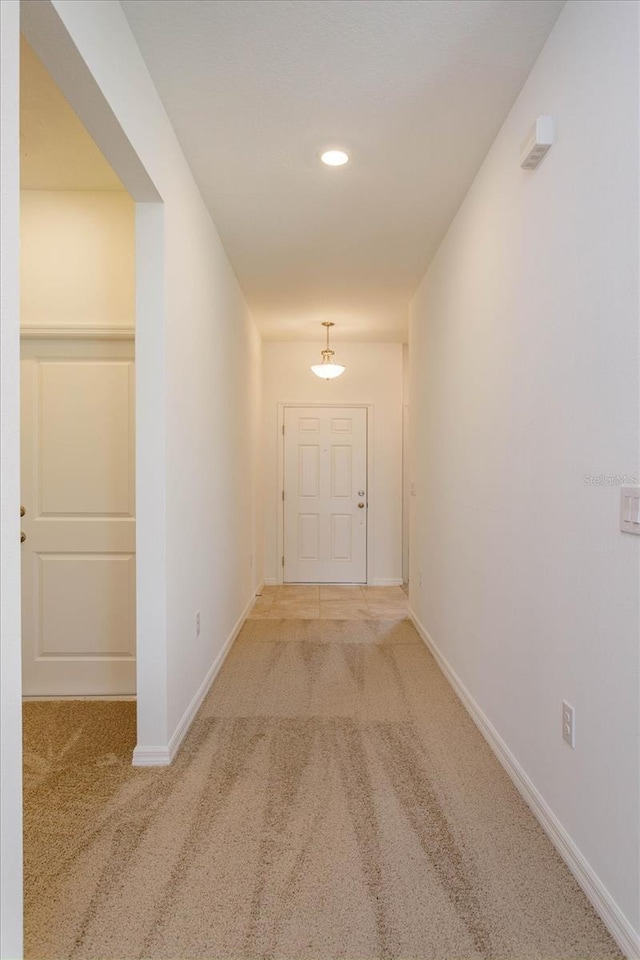 hallway with carpet floors