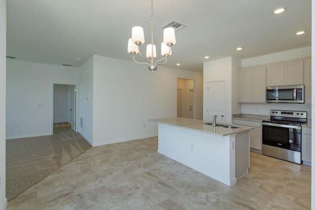 kitchen with a center island with sink, decorative light fixtures, light stone counters, stainless steel appliances, and a chandelier