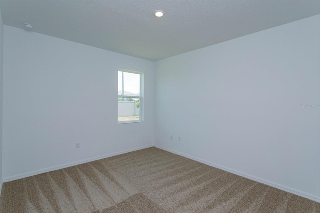 unfurnished room featuring carpet