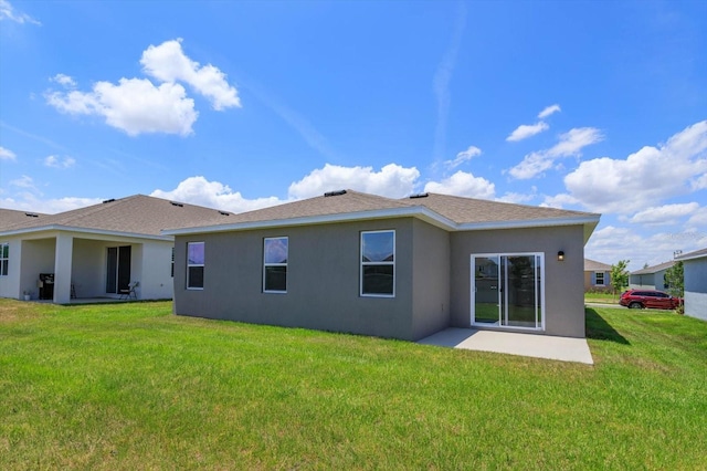 rear view of property with a yard and a patio area