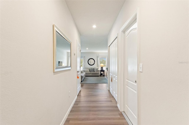 hallway with light hardwood / wood-style floors