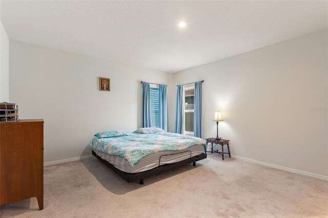 carpeted bedroom with a textured ceiling