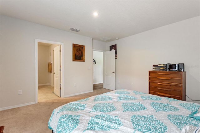 carpeted bedroom featuring ensuite bath