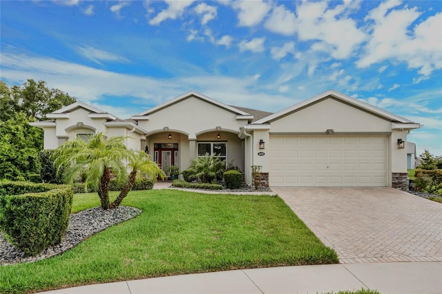 ranch-style house with a garage and a front lawn