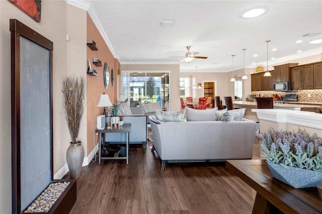 living room featuring crown molding, ceiling fan, and dark hardwood / wood-style flooring