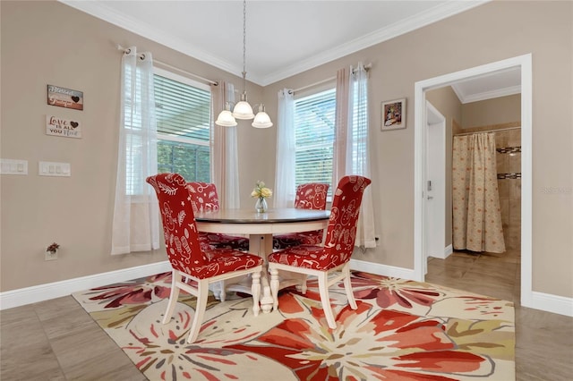 dining room with tile floors and crown molding