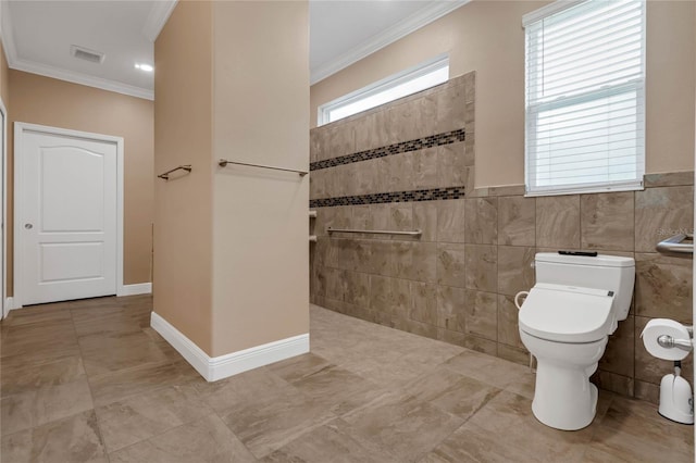 bathroom featuring tile floors, ornamental molding, toilet, and tile walls