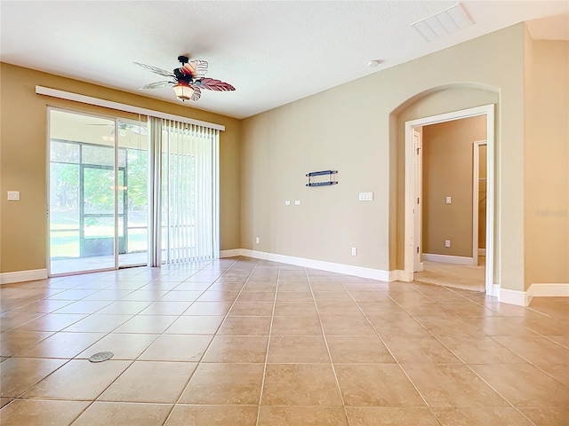 tiled spare room featuring ceiling fan