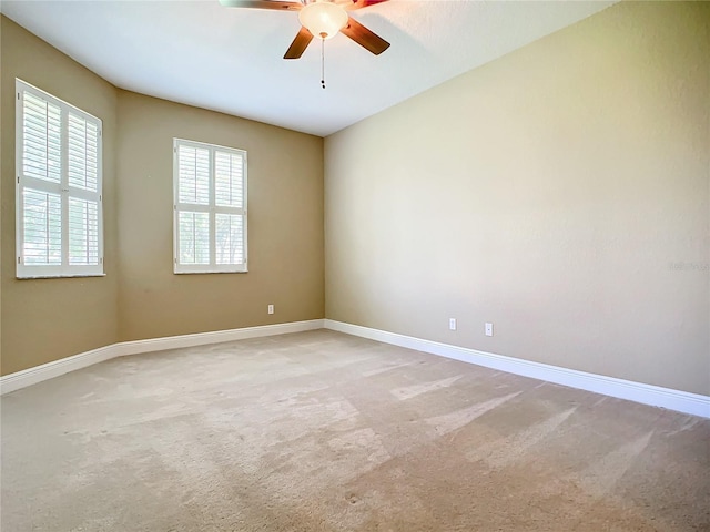 spare room featuring carpet floors and ceiling fan