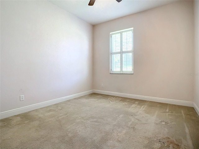 empty room featuring carpet floors and ceiling fan