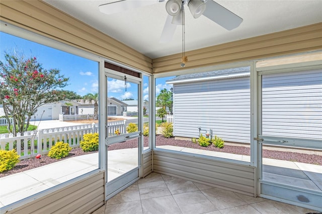 unfurnished sunroom featuring plenty of natural light and ceiling fan