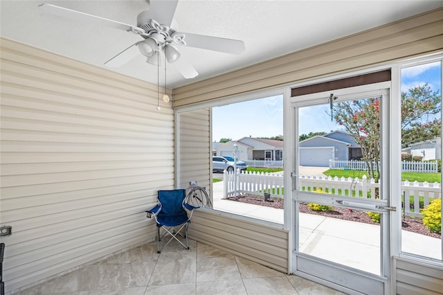 sunroom / solarium featuring ceiling fan