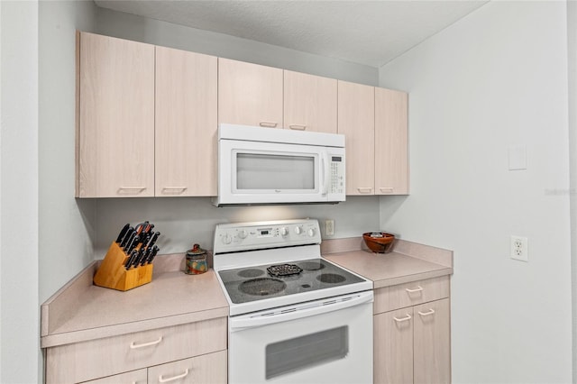 kitchen featuring white appliances and light brown cabinetry