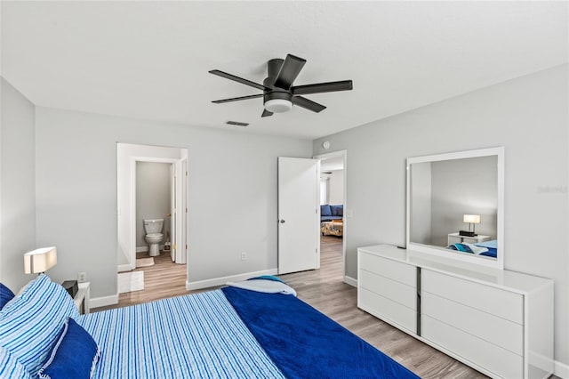 bedroom featuring connected bathroom, hardwood / wood-style flooring, and ceiling fan