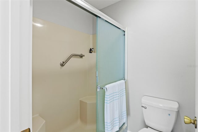 bathroom with toilet and walk in shower