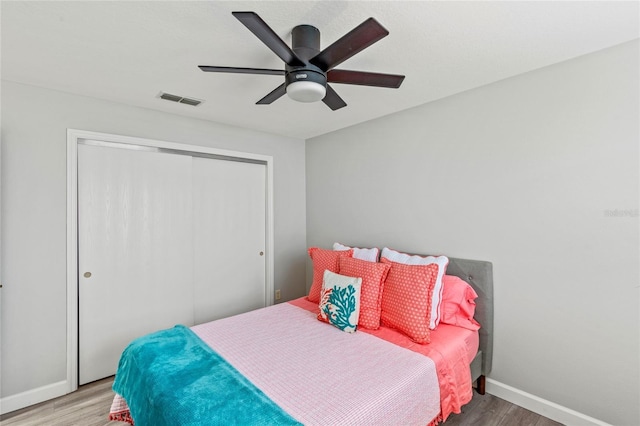 bedroom featuring ceiling fan, a closet, and hardwood / wood-style floors