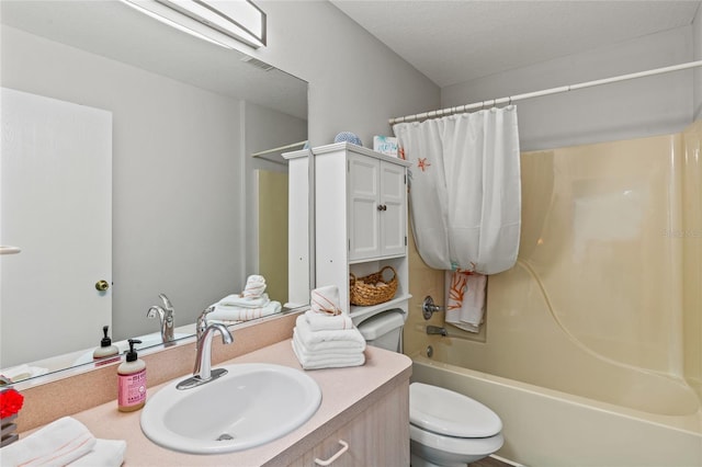 full bathroom with shower / bath combination with curtain, vanity, a textured ceiling, and toilet