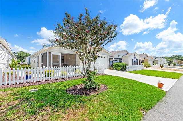 view of front of property with a garage and a front lawn