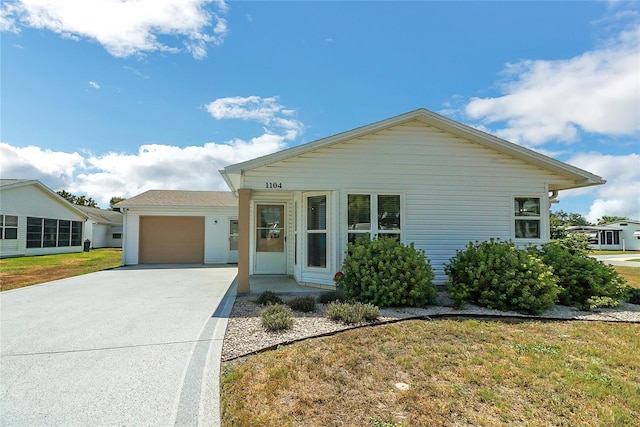 view of front facade with a garage and a front lawn