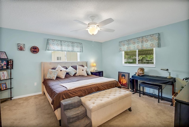 carpeted bedroom with a textured ceiling and ceiling fan