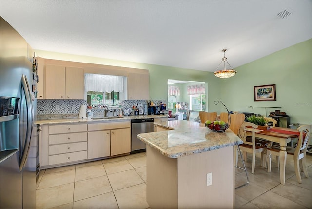 kitchen featuring sink, light tile patterned floors, pendant lighting, and appliances with stainless steel finishes