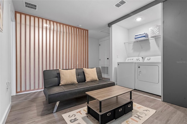 living room featuring washer and clothes dryer and hardwood / wood-style flooring