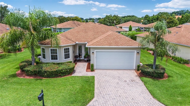 view of front facade with a front lawn and a garage