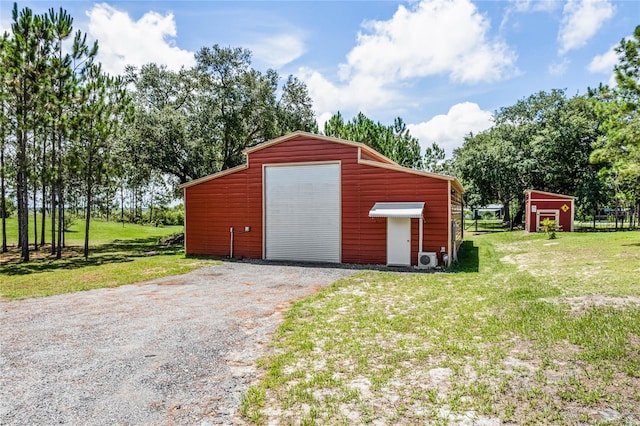 view of outbuilding with a garage and a lawn