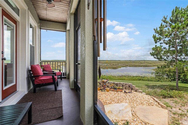 sunroom / solarium featuring a healthy amount of sunlight and a water view