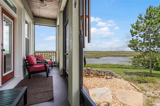 sunroom / solarium with a water view