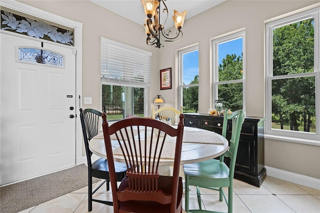 dining space with a chandelier, plenty of natural light, and light tile floors