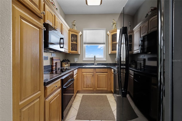 kitchen featuring light tile patterned flooring, sink, and black appliances