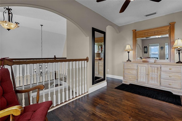 bathroom featuring hardwood / wood-style flooring, ceiling fan, and a textured ceiling