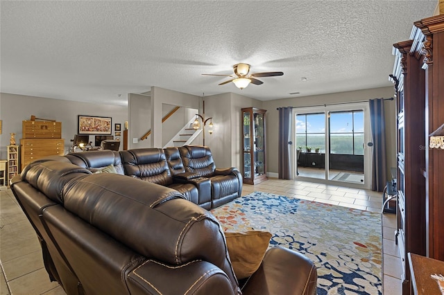 tiled living room featuring a textured ceiling and ceiling fan