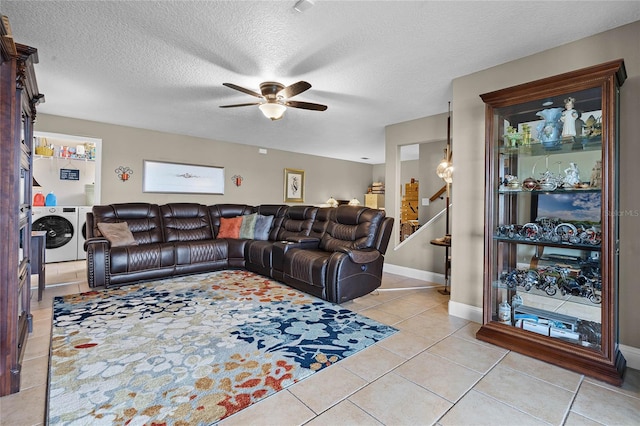 tiled living room with washer and dryer, ceiling fan, and a textured ceiling