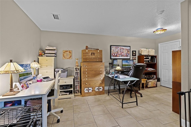 home office featuring a textured ceiling and light tile flooring