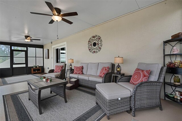 carpeted living room with ceiling fan