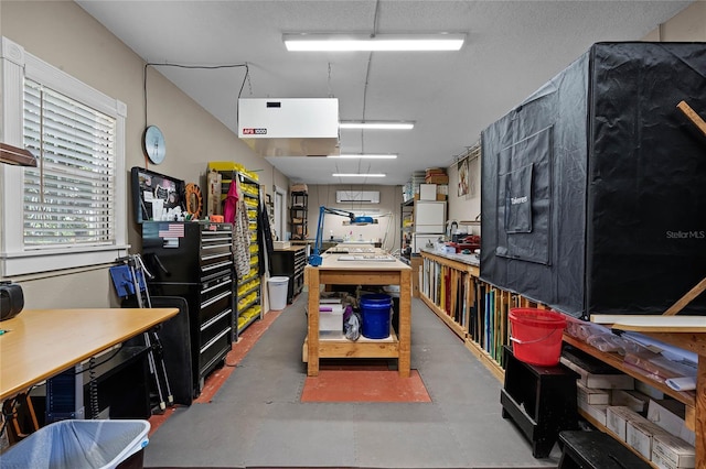 misc room with concrete flooring and a workshop area