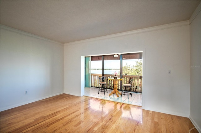 unfurnished room with hardwood / wood-style flooring and ornamental molding