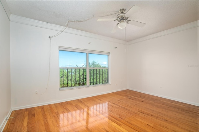 spare room featuring hardwood / wood-style flooring, ornamental molding, ceiling fan, and a textured ceiling