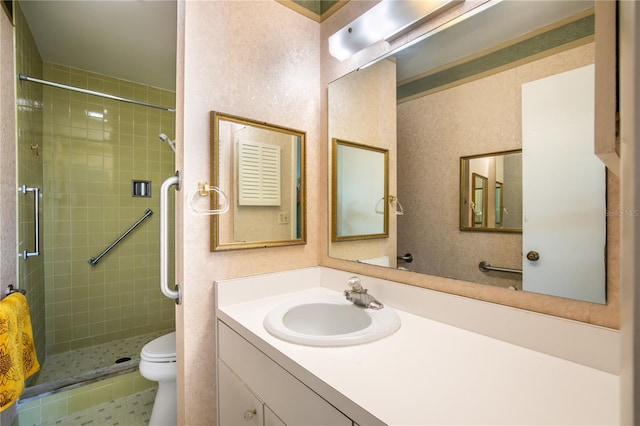 bathroom featuring vanity, toilet, and a shower with door