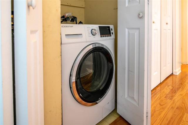 washroom featuring wood-type flooring and washer / dryer