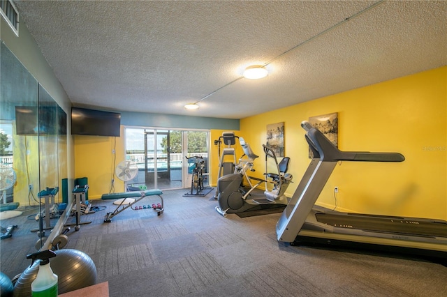 exercise room with a textured ceiling