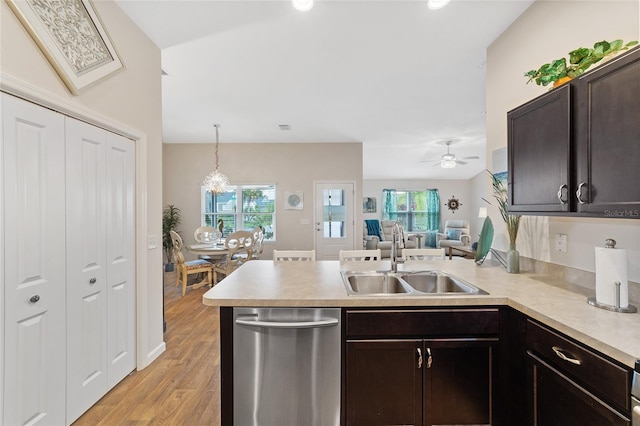 kitchen with ceiling fan, sink, stainless steel dishwasher, kitchen peninsula, and pendant lighting