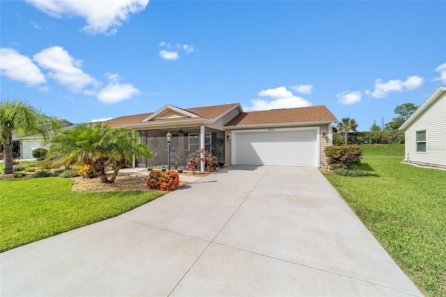 ranch-style house with a garage, a front lawn, and ceiling fan