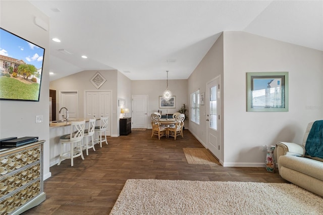 interior space with sink, lofted ceiling, and dark wood-type flooring