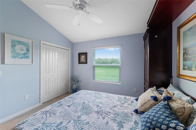 carpeted bedroom with ceiling fan, lofted ceiling, and a closet